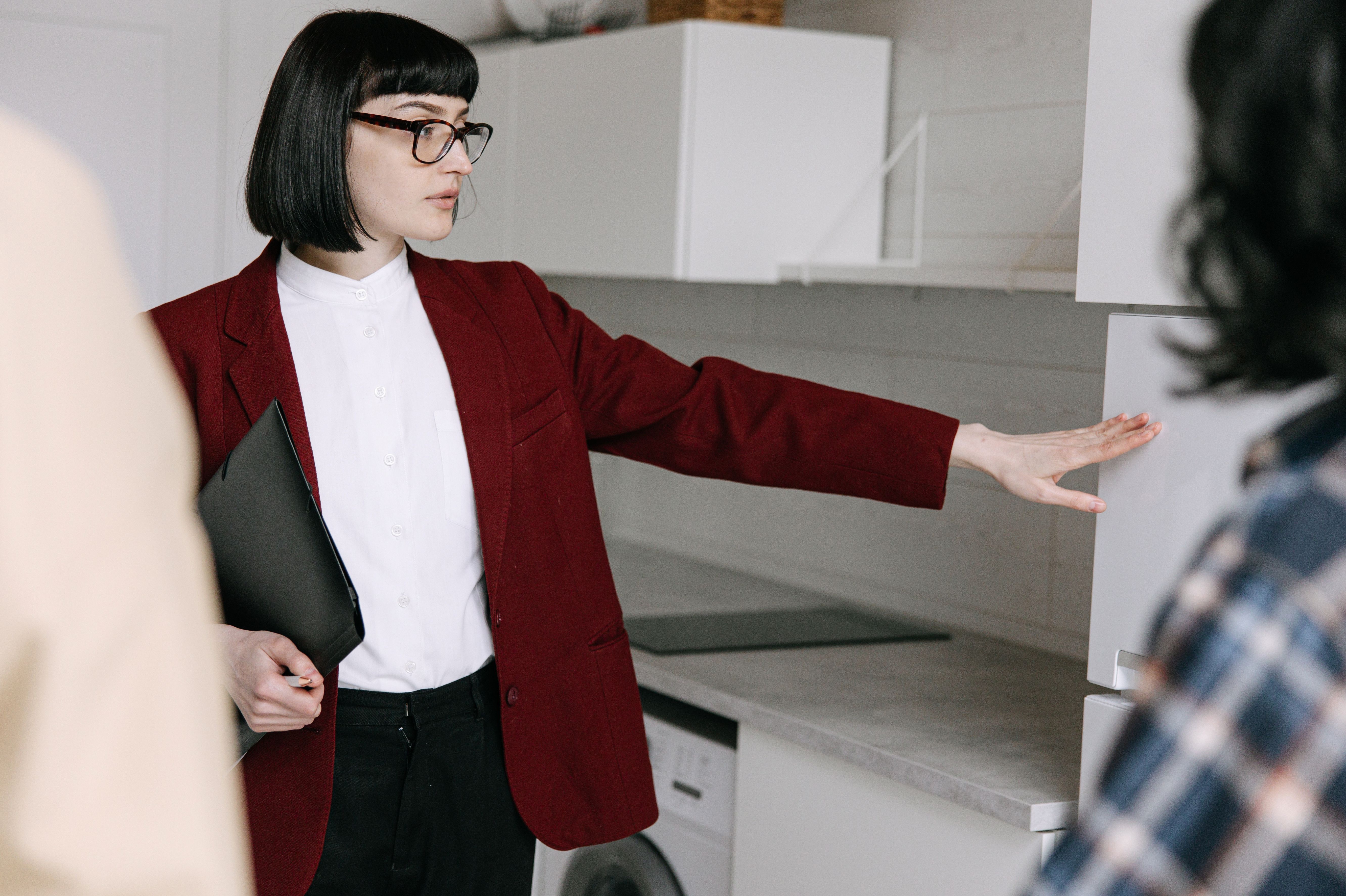 Property manager in red showing a rental to tenants